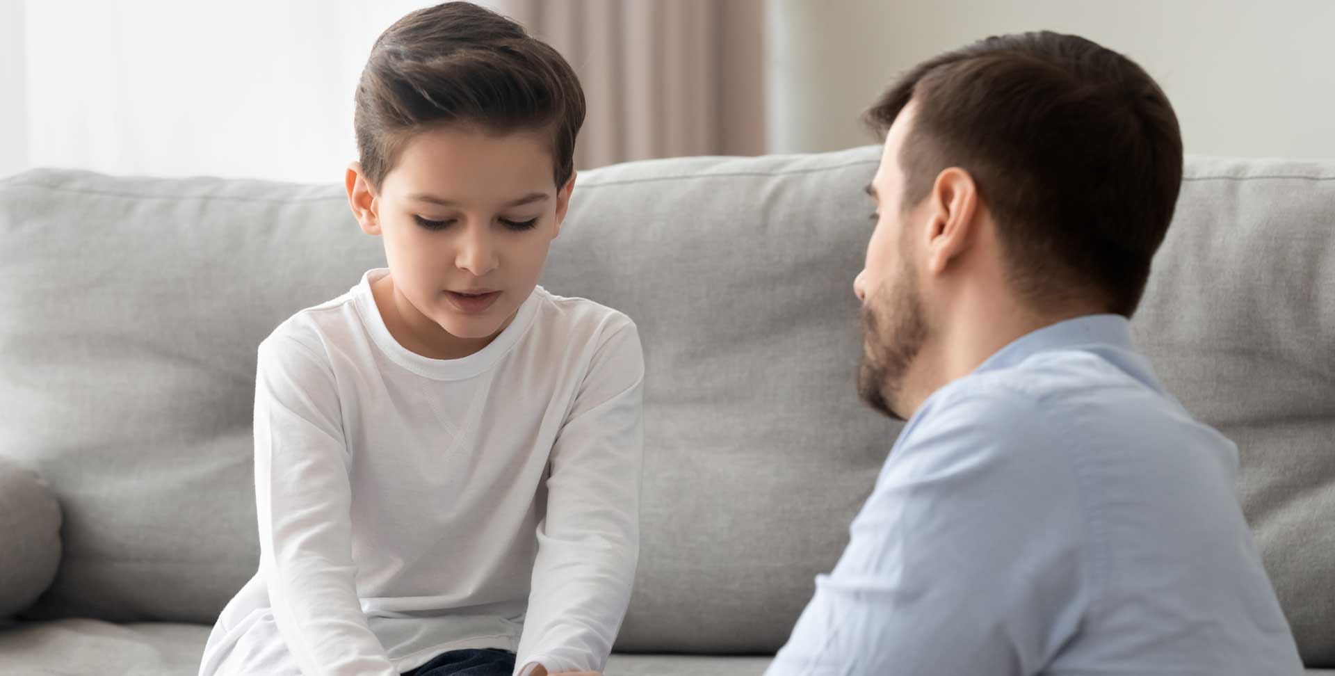 A father comforts his young son