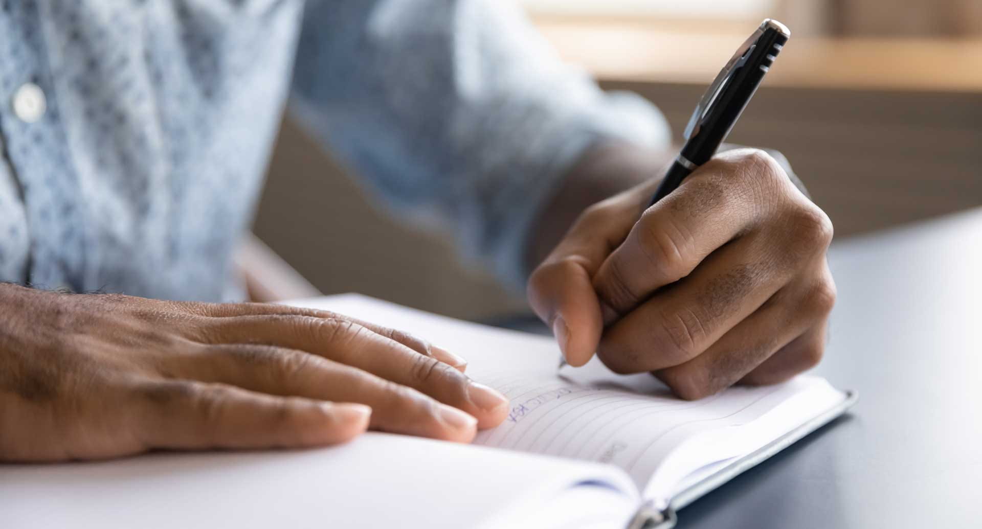 A hand writing in a journal