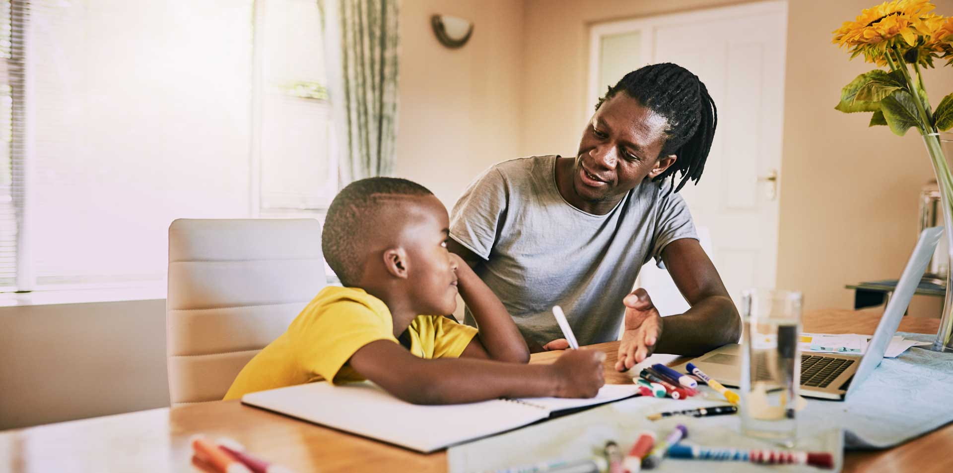 A father is tutoring his young son