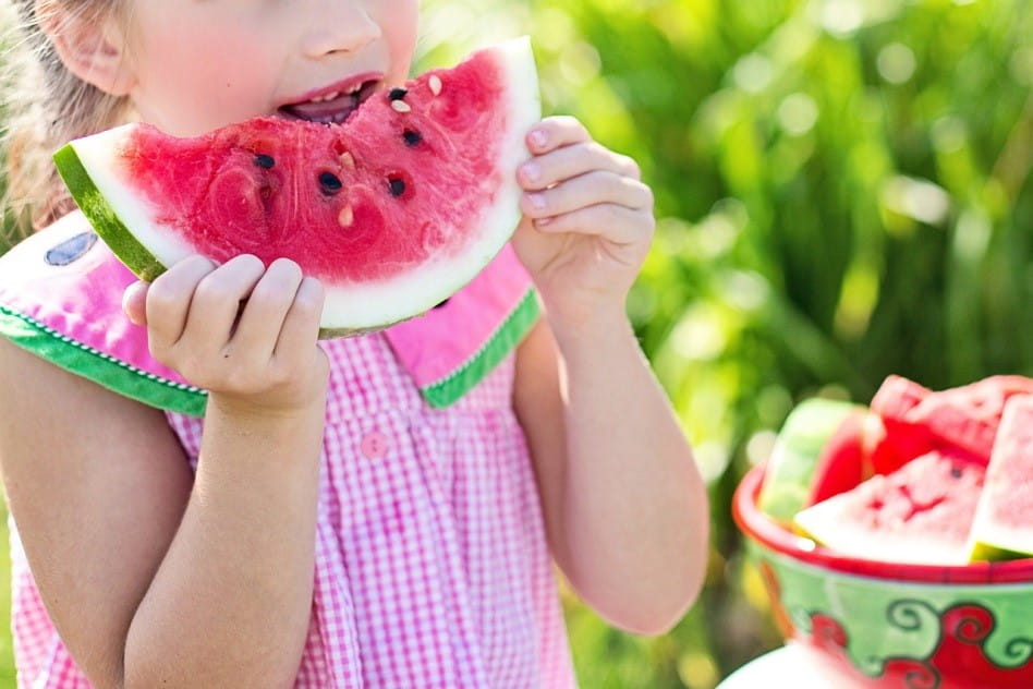 A child eats a watermelon